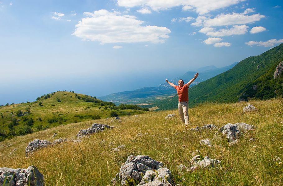 Happy man on a beautiful mountain nature in Crimea, Ukraine
